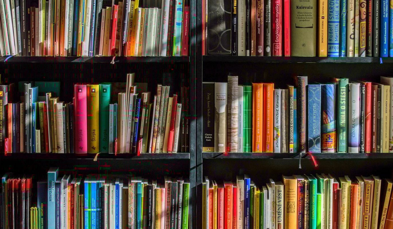 Vibrant paperback and hardback books on bookshelves reflecting inspirational reads Sharman recommends on mindset, leadership, faith, and success. Vibrant paperback and hardback books on bookshelves reflecting inspirational reads Sharman recommends on mindset, leadership, faith, and success.