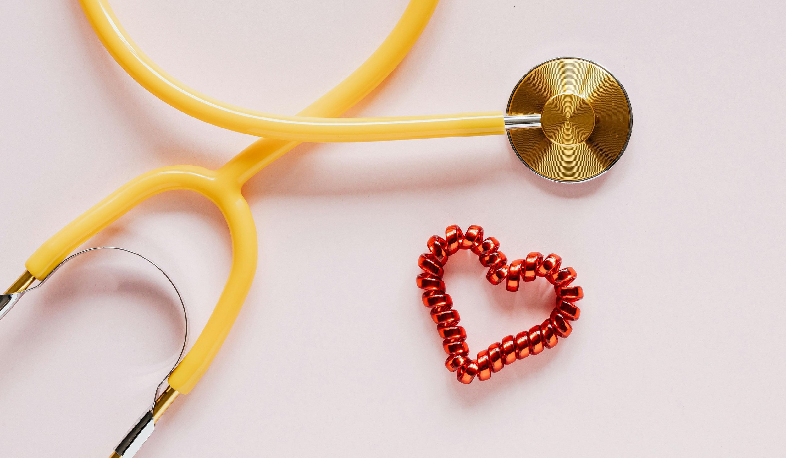 Visual of stethoscope and red heart beads, illustrating cost-effective health solutions, access to care, and alternatives to traditional insurance