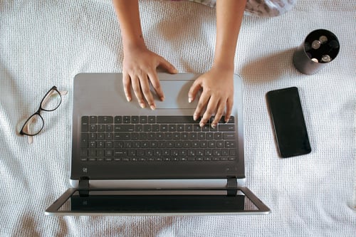 Person typing on laptop, representing blogging, personal growth insights, and sharing strategies for becoming your best self