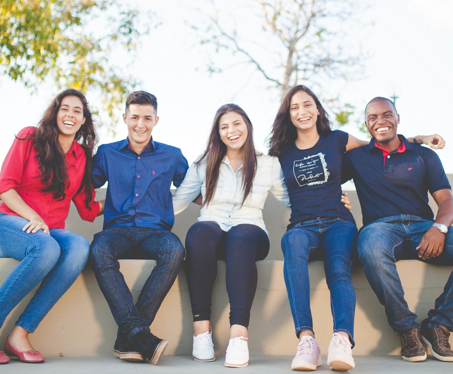 Happy, diverse group of adults connecting in a positive environment, highlighting mentorship, personal growth and lifestyle flexibility via residual income